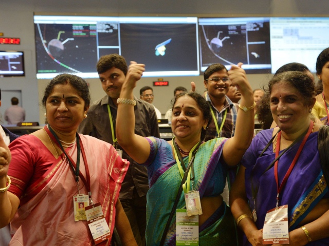 Indian staff from the Indian Space Research Organisation (ISRO) celebrate after the Mars Orbiter Spacecraft (MoM) successfully entered the Mars orbit at the ISRO Telemetry, Tracking and Command Network (ISTRAC) in Bangalore on September 24, 2014. India became the first nation to reach Mars on its maiden attempt September 24 when its low-cost Mangalyaan spacecraft successfully entered orbit around the Red Planet after a 10-month journey. "India has successfully reached Mars... History has been created today," a jubilant Prime Minister Narendra Modi said from mission control after entry into orbit was confirmed at 8:02am (0232 GMT). AFP PHOTO/Manjunath KIRANManjunath Kiran/AFP/Getty Images